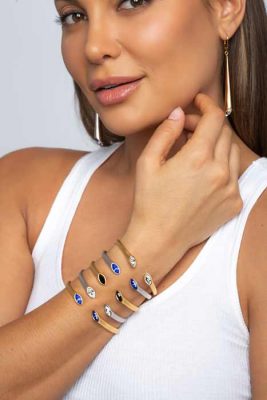 Beautiful woman with banded hand with ARY D'PO Urban Marquise Collection Mate Rhodium and gold Plated Lever back Earrings and cuff bracelets hinged with Swarovski crystals