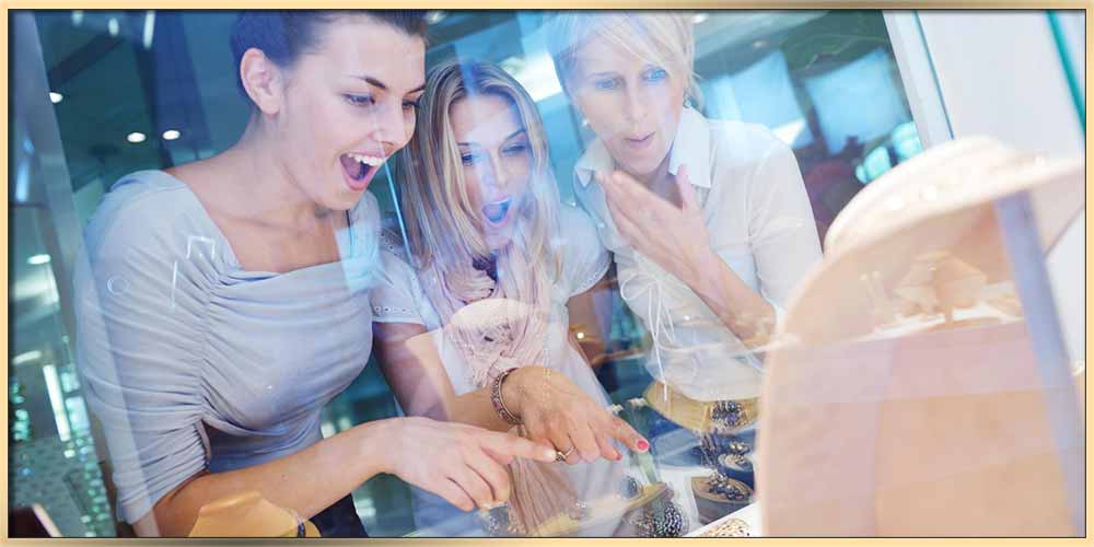 An image of three young women looking into the jewelry store through the window featured for Why Do Women Love Jewelry? article