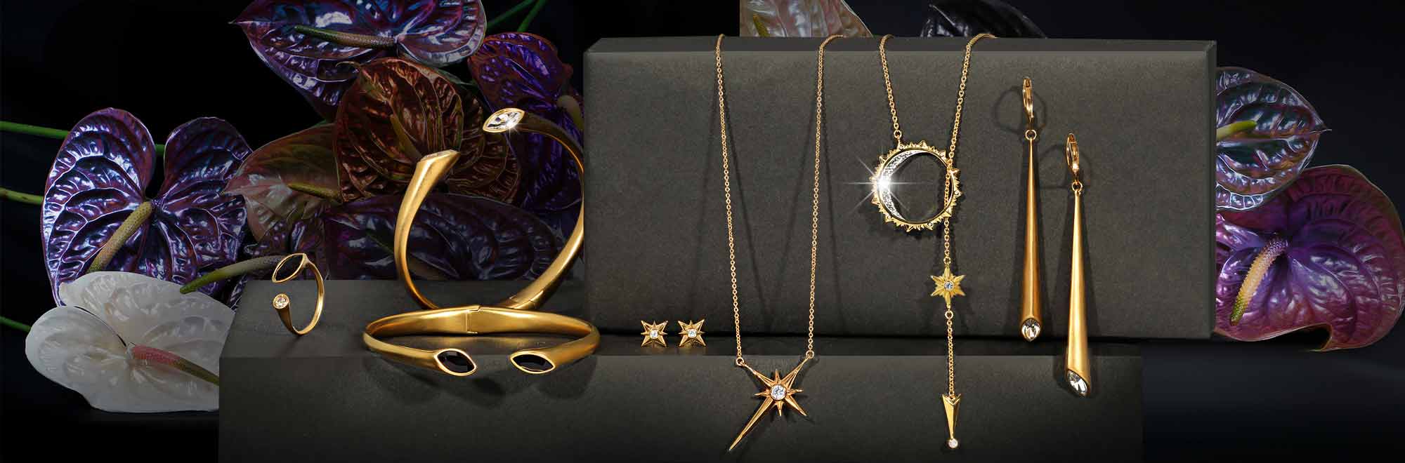 Arydpo jewelry in gold on a black background