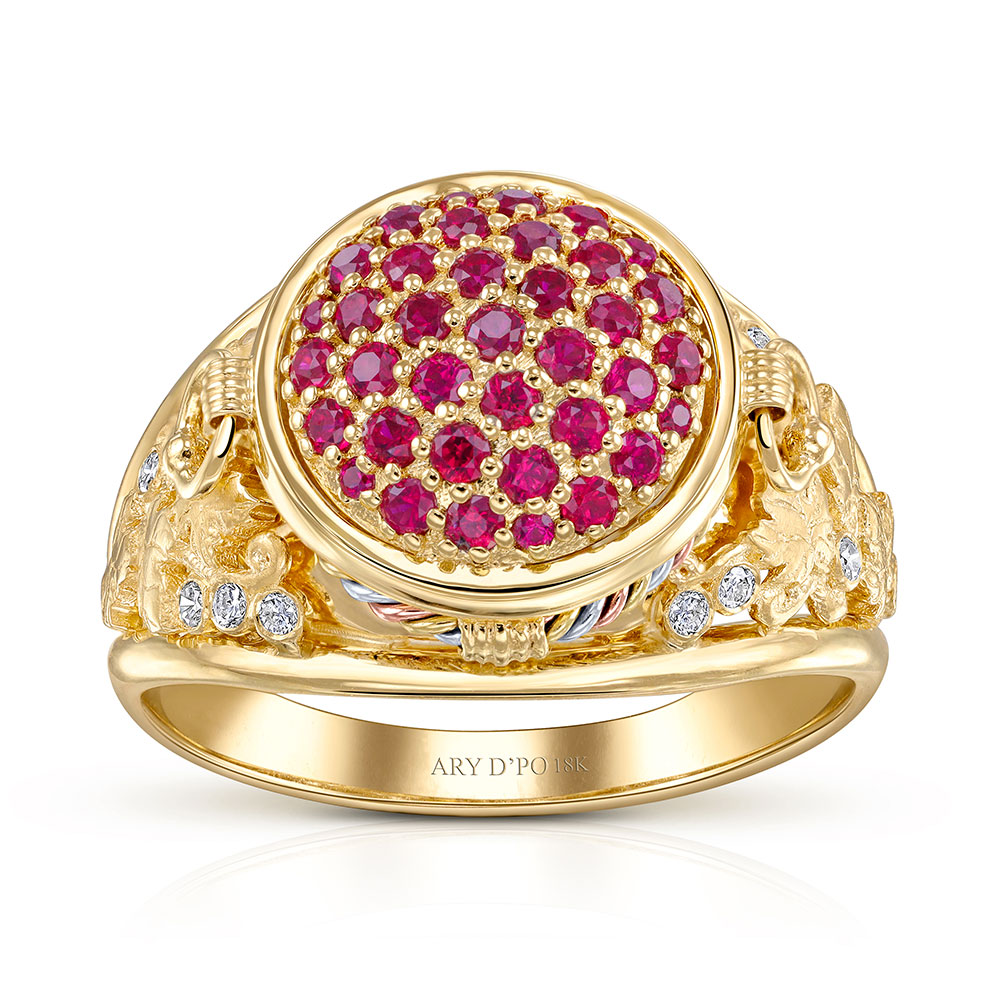 The Karas Tribute Ring designed by ARY D'PO: A luxurious piece of wearable art, this 18K Yellow Gold cocktail ring is meticulously crafted in the shape of a traditional Armenian Karas (wine jar). The design tells a story: vibrant, deep-red rubies symbolize the rich wine held within, while sparkling, pave-set diamonds represent pure water droplets, essential for the vine. The setting is completed with hand-sculpted gold grape leaves adorning the sides, celebrating the ancient art of winemaking. This unique ring is a true conversation starter and an heirloom piece.